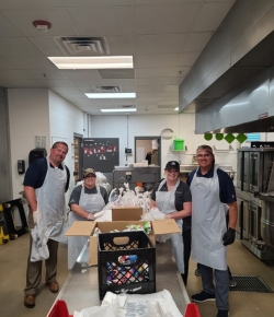 ACCESSbank employees volunteering in a kitchen.
